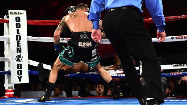 Over and out: Bernard Hopkins falls out of the ring after a punch from Joe Smith Jr. 