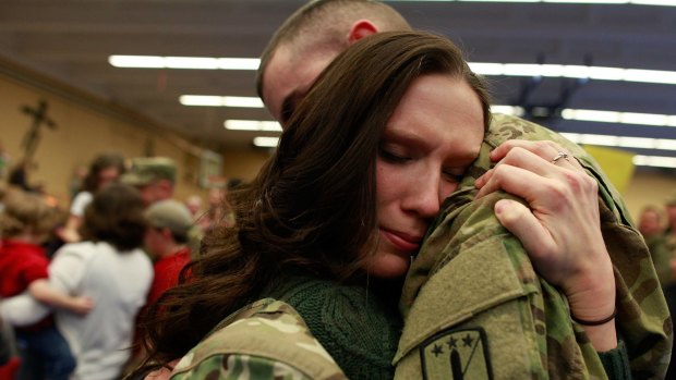 A soldier of the 170th US Army Infantry Brigade is greeted upon his return from Afghanistan at a US Army base in Germany in 2012.