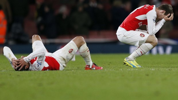 Not good enough: Arsenal players react after losing at home to Swansea. 