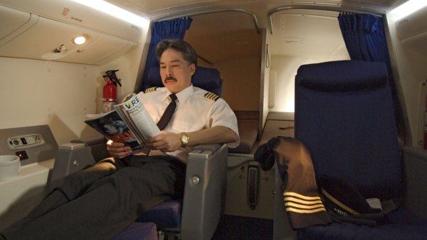 The pilot rest area on a Boeing 777 features two seats with two bunk-style beds behind.