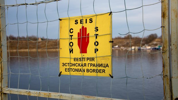 A sign at the Narva River, which forms part of Estonia's border with Russia.