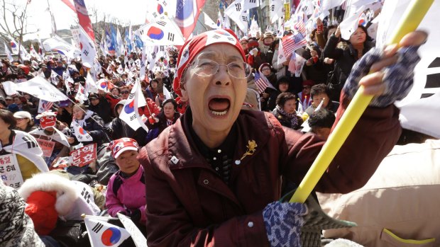 A supporter of South Korean President Park Geun-hye cries during a rally opposing her impeachment near the Constitutional Court in Seoul.