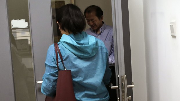 Chen Yun, left, walks past Dr Liu Jiaen at a hospital in Beijing where she's undergoing IVF treatment. 