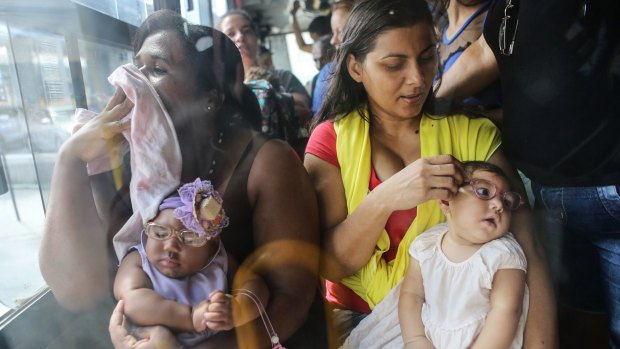 Brazilian mothers Jusikelly, right, and Inabela hold their daughters Luhandra and Graziella, both born with microcephaly.
