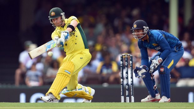 Taking a swing: Australian batsman Michael Clarke sweeps a ball as Sri Lanka wicketkeeper Kumar Sangakkara looks on.