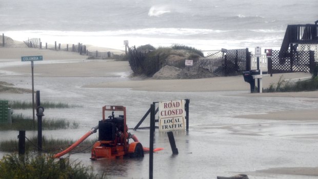 A pump sits in the middle of a flooded street in Ocean Isle Beach, North Carolina on Sunday.