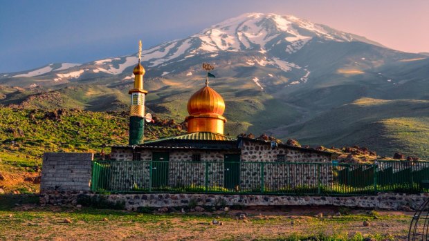 A picturesque mosque stands underneath the volcano Damavand, the highest peak in Iran.