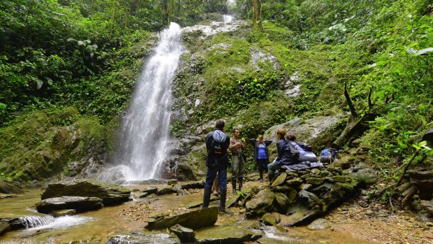 Walkers rest at the base of one of the many waterfalls close to the lodge.