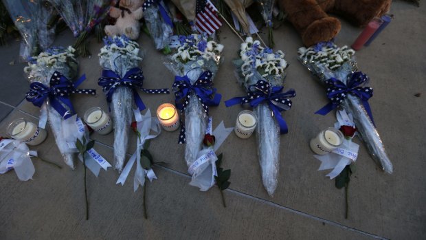 Candles and flowers placed in honour of slain  police officers in front of police headquarters in Dallas.