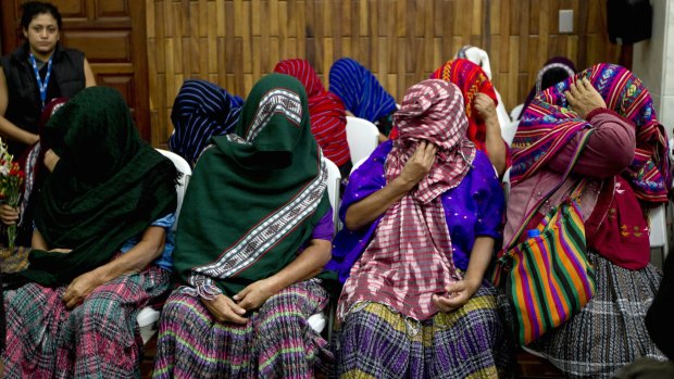 Victims of sexual violence hide their faces during the trial against former military officer and a former paramilitary fighter convicted of sexual violence against indigenous women during Guatemala's civil war, in Guatemala City.