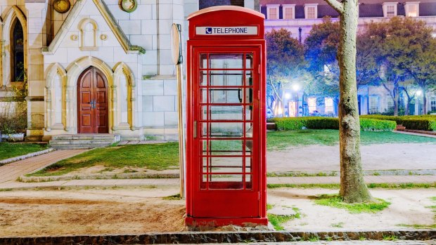English style telephone box at night in Thames Town Shanghai.