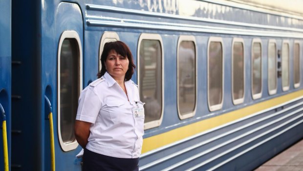 A passenger car attendant by an Odessa train at Kiyevsky Railway Terminal.