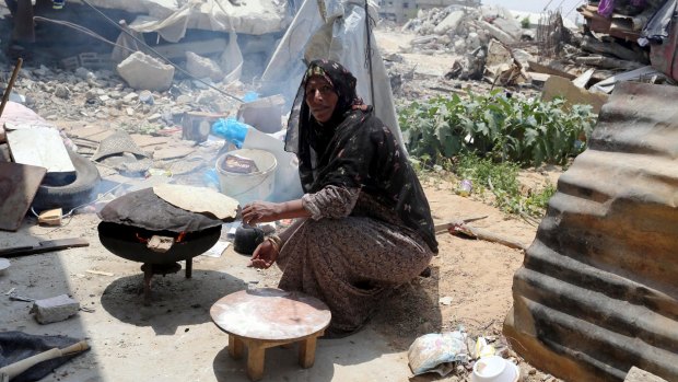 Baking  bread outside a makeshift shelter in the southern Gaza Strip this week. 