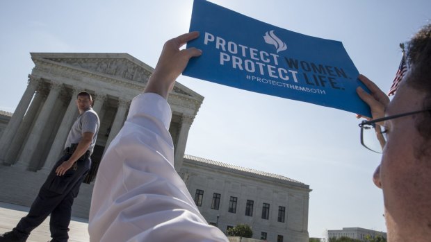 An anti-abortion activist stands in front of the Supreme Court in Washington as the judges struck down the strict Texas anti-abortion restriction law known as HB2. 
