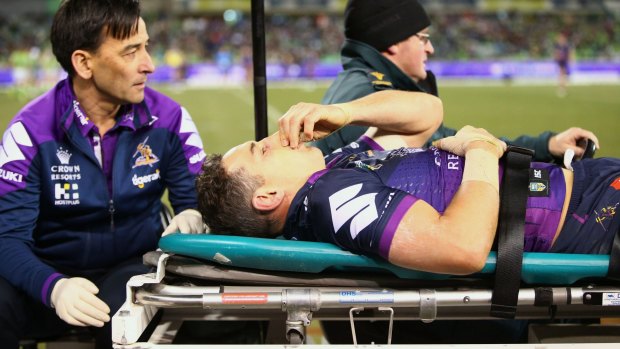 Awful sight: A concussed Billy Slater is assisted from the field.