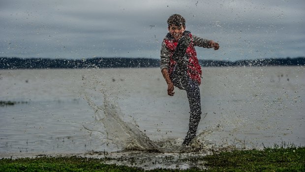 Tom Osborne, 11, splashes around in Lake George. 