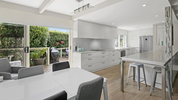 An open-plan living, dining and kitchen area is the property's central hub. 