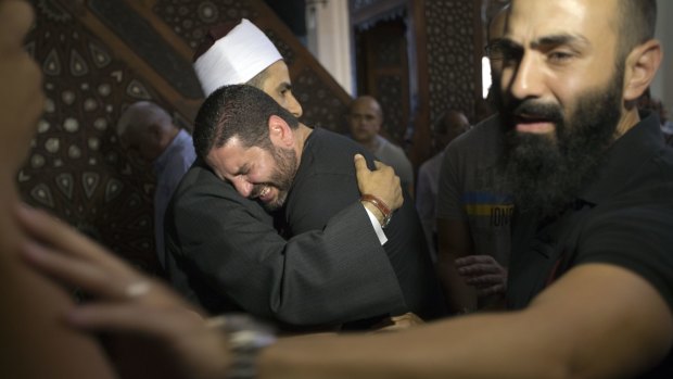 The Imam of al Thawrah Mosque, Samir Abdel Bary, gives condolences to film director Osman Abu Laban, centre, who lost four relatives in the EgyptAir plane crash, at al Thawrah Mosque in Cairo.