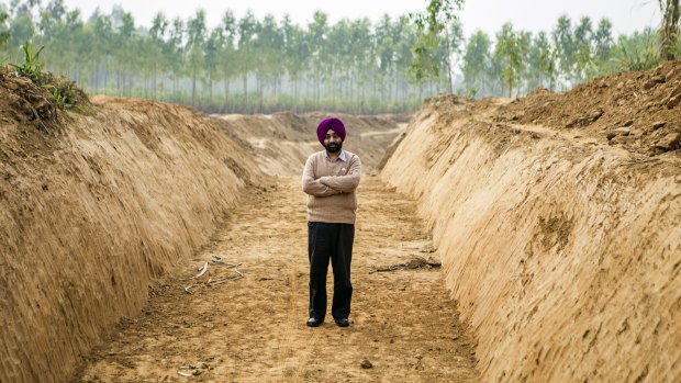 Gagandeep Singh, a development officer for Yamuna Nagar district, stands for a photograph at the site of a newly-dug canal, along the purported ancient route of the Saraswati.
