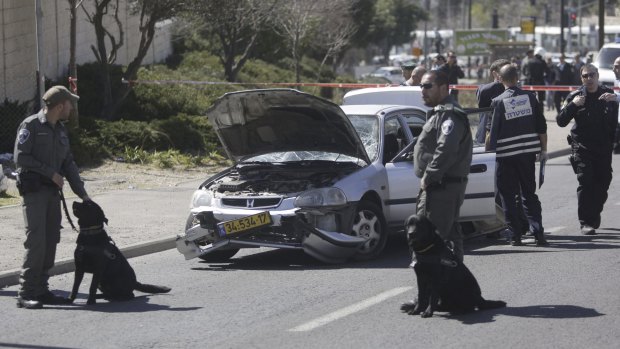 Attack: Israeli police inspect the car used in the ramming in Jerusalem.