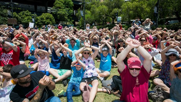 Protesters at First Fleet Park in Sydney clasp arms in the air to demonstrate solidarity with the men on Manus inj November.