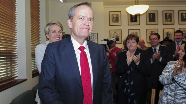Leader Bill Shorten and deputy Tanya Plibersek are applauded as they arrive for the caucus meeting on Friday.