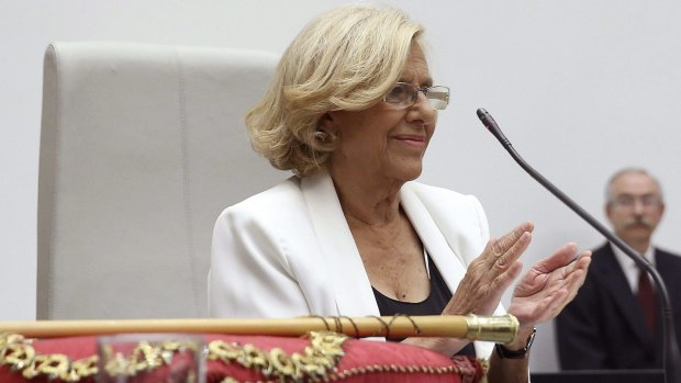 Manuela Carmena applauds after being sworn in as mayor of Madrid.