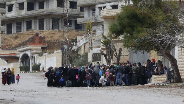 Syrians wait for an aid convoy in the besieged town of Madaya in the countryside of Damascus, Syria on January 14.