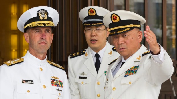 US Chief of Naval Operations Admiral John Richardson, left, listens to Commander of the Chinese Navy Admiral Wu Shengli, right, at Chinese Navy Headquarters in Beijing in 2016.