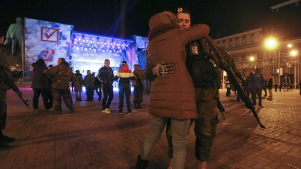 A pro-Russian separatist embraces a woman at the close of the controversial ballot in Donetsk.