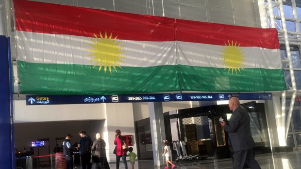 A Kurdish flag hangs in the Irbil International Airport, in Iraq, on Wednesday. Iraq has ordered the Kurdish region to hand over control of its airports to federal authorities or face a flight ban.