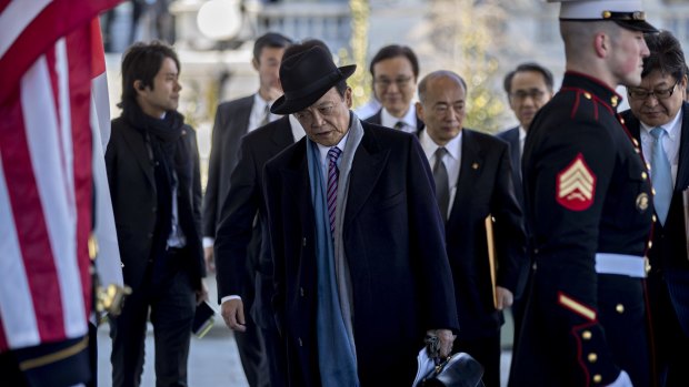Japanese Deputy Prime Minister Taro Aso arrives at the White House.