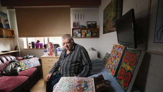 Sambell Lodge resident Graeme Doyle in his room, surrounded by his artwork. 