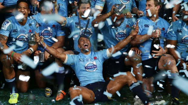 Happy days: Kurtley Beale celebrates with his Waratahs teammates after their 2014 Super Rugby championship win.