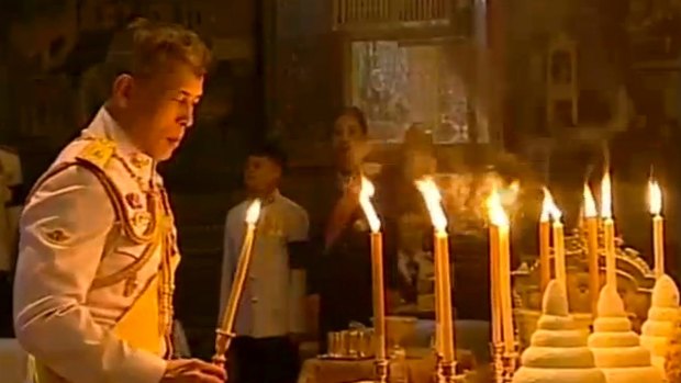 Thailand's new King Maha Vajiralongkorn Bodindradebayavarangkun lights candles for his father at the Grand Palace in December.