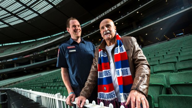 Thanks, mate: Western Bulldogs fan Rob McCarthy (right) is reunited with paramedic Liam Moore, who saved his life with CPR. 