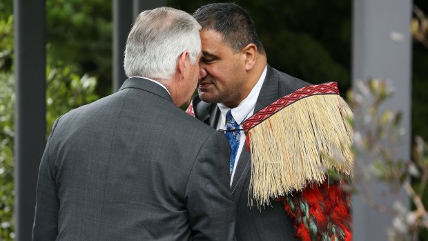 Rex Tillerson is greeted with a hongi by Parliamentary kaumatua Kura Moeahu and Defence Minister Gerry Brownlee on Tuesday.