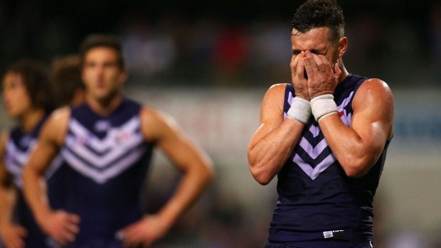 Ryan Crowley shows his disappointment after Fremantle was beaten by Port Adelaide in the first semi-final in 2014, his last game for the club since his suspension.