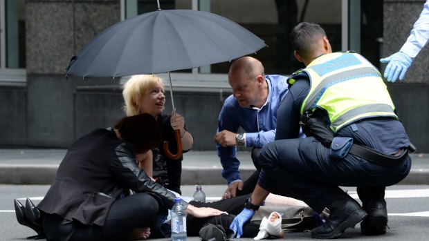Bystanders comforted the injured in Bourke Street.