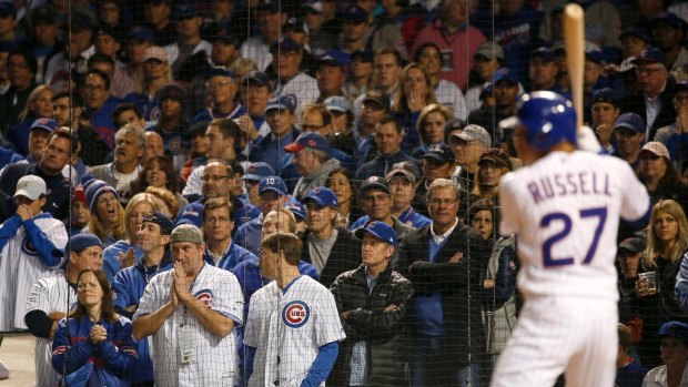 Fans watch as Cubs' Addison Russell gets ready to bat during the eighth inning.
