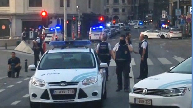 In this image taken from video, police cars block a road near the train station in central Brussels on Tuesday.