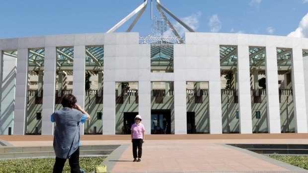 Tourists on the forecourt of Parliament House in Canberra.