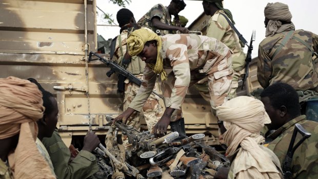 Chadian soldiers collect weapons seized from Boko Haram fighters in Damasak, Nigeria, earlier this month.  