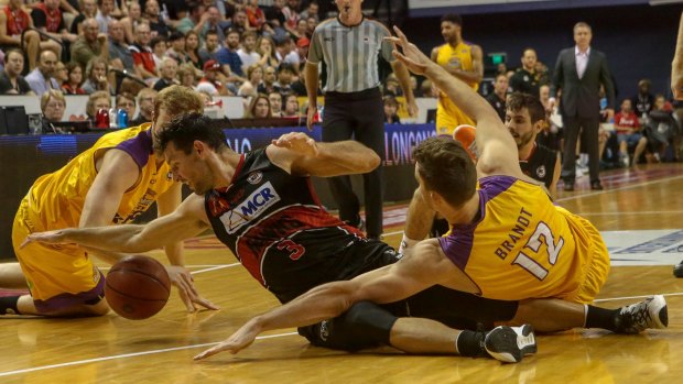 Scramble: Hawks guard Kevin White tries to get his hands on the ball.