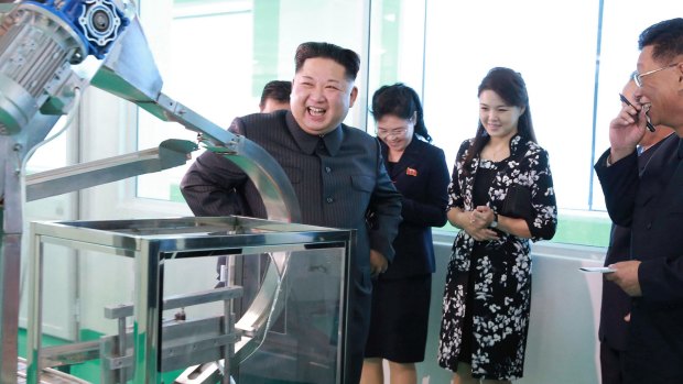 North Korean leader Kim Jong-un, centre, and his wife, Ri Sol-ju, second from right, visit a cosmetics factory in Pyongyang.