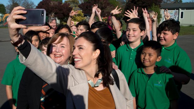 New Zealand Labour Party leader Jacinda Ardern, front right, takes a selfie with school children in Christchurch.