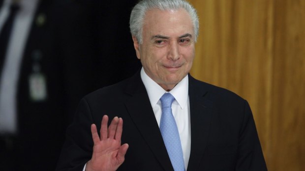 Brazilian President Michel Temer arrives to give a statement in Brasilia, after surviving a key congressional vote that could have suspended him over a bribery charge. 