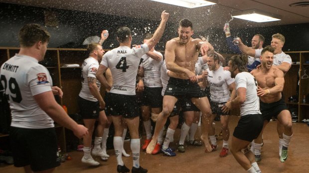 Off the mark: Toronto Wolfpack players celebrate in the locker room after their 62-12 win over Oxford.