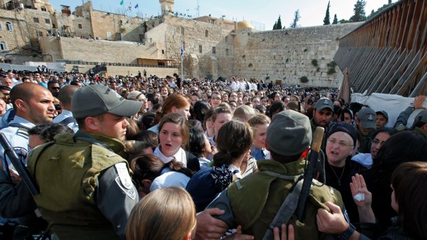 Israeli police attempt to keep order as Orthodox women and girls block members of Women of the Wall from praying at the site in 2013.