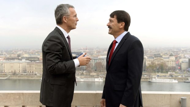 NATO Secretary General Jens Stoltenberg, left, and Hungarian President Janos Ader chat on the terrace during their meeting in the presidential Alexander Palace in Budapest, Hungary last week.